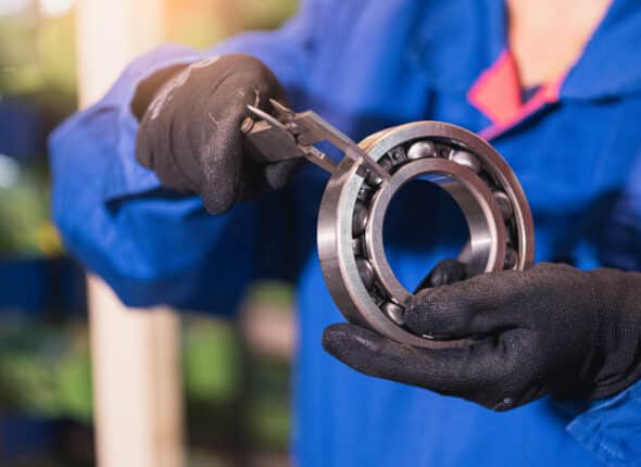 Bearing and lubrication inspection using precision measurement tools on an industrial bearing to ensure proper fit, performance, and reliability in maintenance operations.